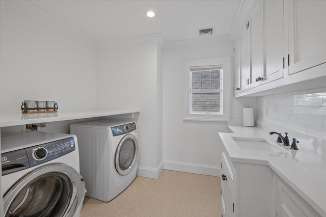 laundry room featuring cabinets, independent washer and dryer, ornamental molding, and sink