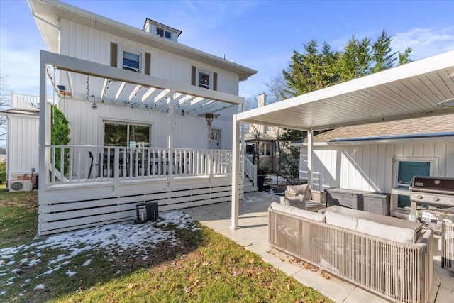 rear view of property with outdoor lounge area, a pergola, a patio, and exterior kitchen