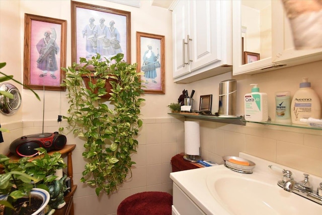 bathroom with vanity and tile walls