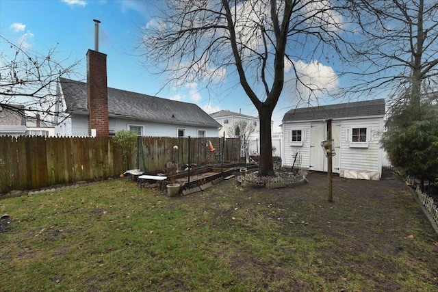 rear view of house featuring a lawn and an outdoor structure