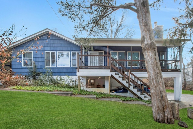 back of property featuring a yard and a sunroom