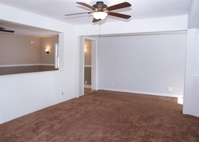 carpeted empty room featuring ceiling fan