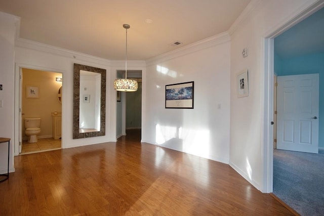 interior space featuring hardwood / wood-style flooring and crown molding