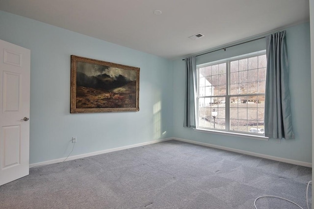 spare room featuring light colored carpet