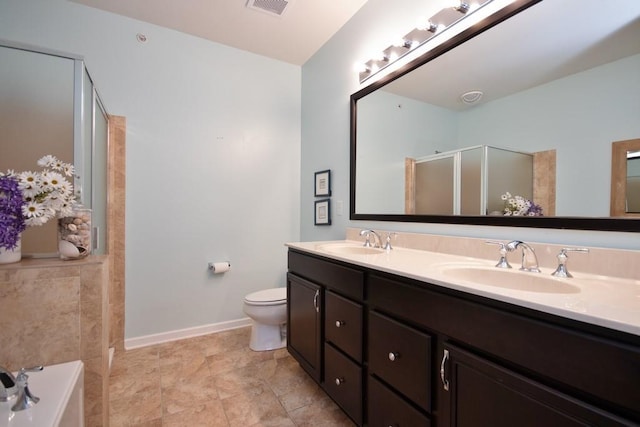 full bathroom featuring vanity, separate shower and tub, and toilet