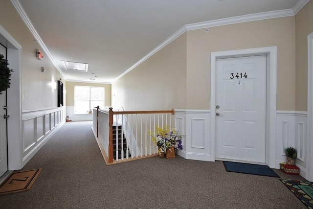 interior space with dark carpet, crown molding, and a skylight