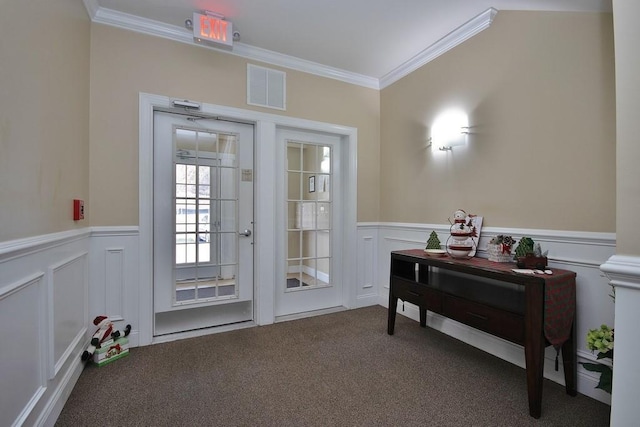 doorway with crown molding and carpet floors