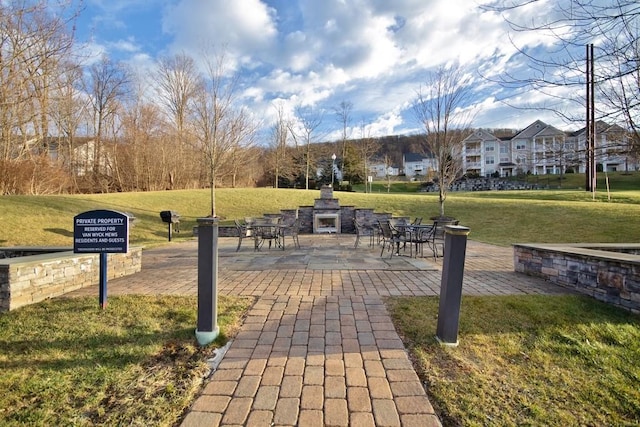 view of community with a patio area and a lawn