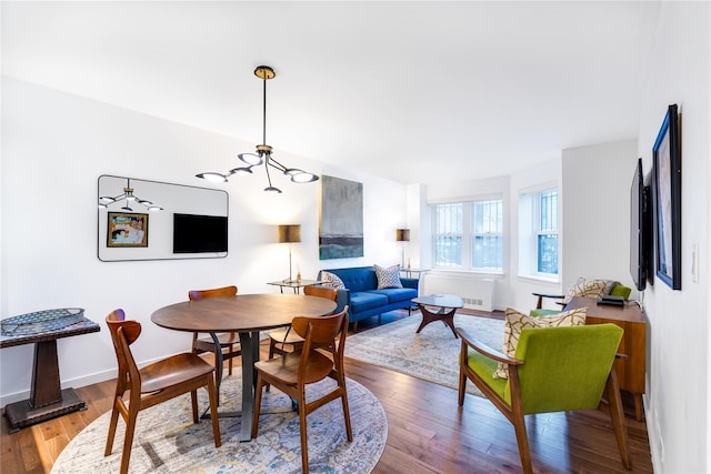 dining area featuring light hardwood / wood-style floors and a chandelier