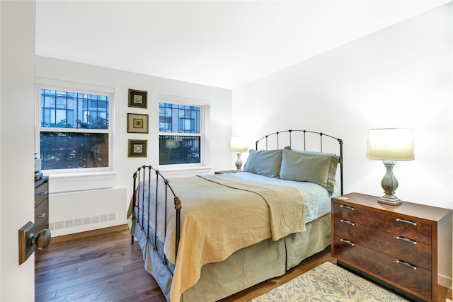 bedroom with dark hardwood / wood-style floors