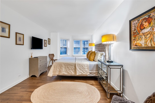 bedroom with dark wood-type flooring