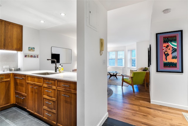 110 W 90th St Unit 1N, New York Manhattan, NY 10024 - kitchen with a sink, light countertops, brown cabinets, wood finished floors, and recessed lighting