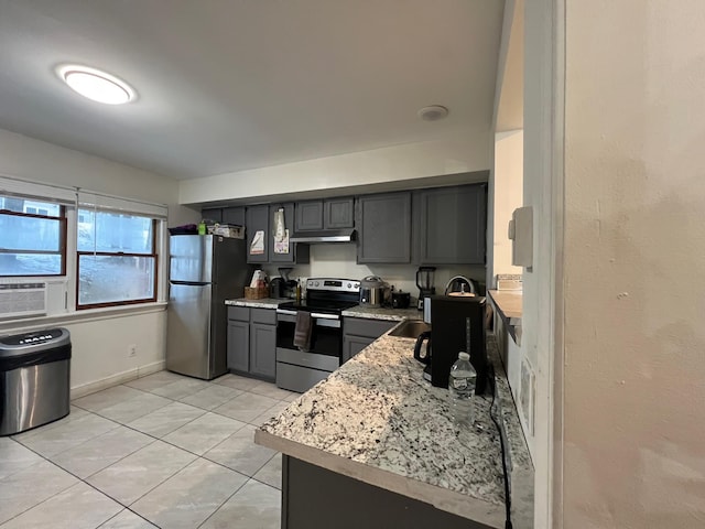 kitchen featuring light tile patterned flooring, appliances with stainless steel finishes, sink, cooling unit, and light stone countertops