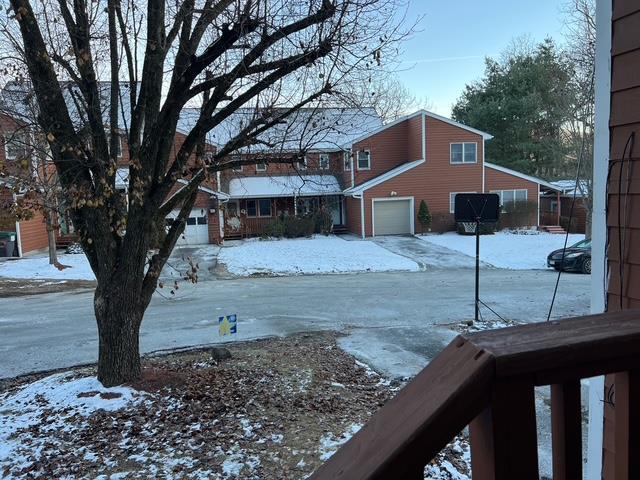 yard layered in snow with a garage