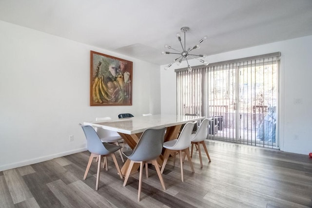 dining room with an inviting chandelier and dark hardwood / wood-style flooring