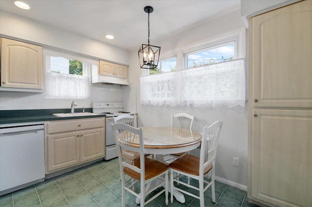 kitchen featuring white appliances, plenty of natural light, hanging light fixtures, and sink