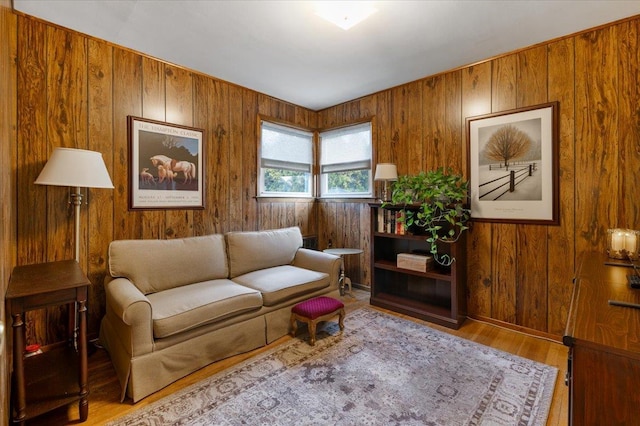 living room featuring wood walls and light hardwood / wood-style flooring