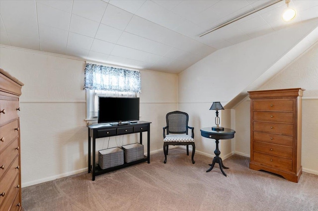 sitting room featuring carpet and vaulted ceiling