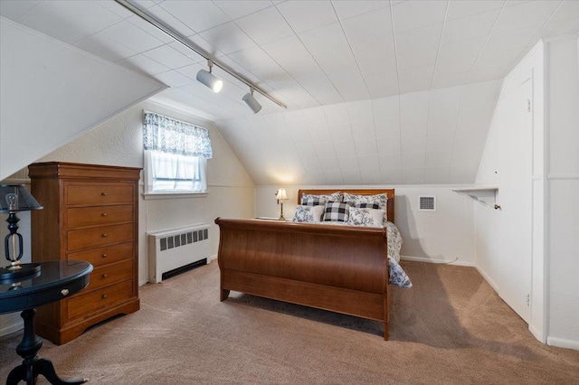 bedroom featuring carpet, radiator heating unit, rail lighting, and lofted ceiling