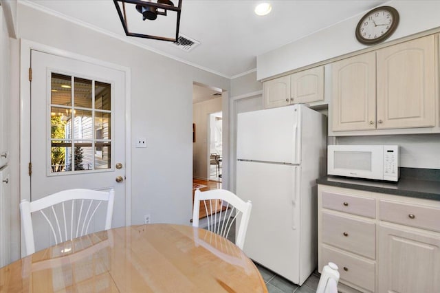 kitchen with white appliances, ornamental molding, and light tile patterned floors