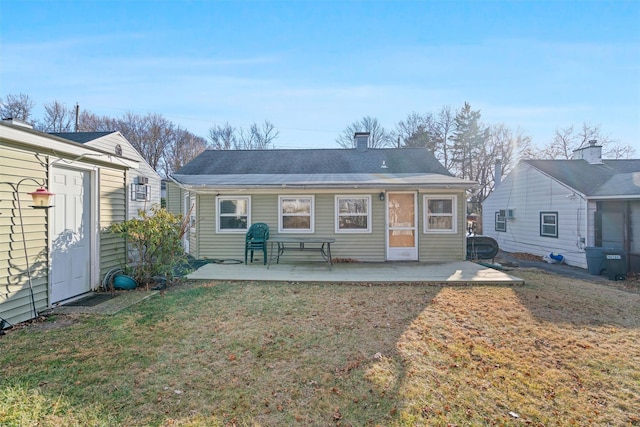 rear view of house with a patio area and a yard