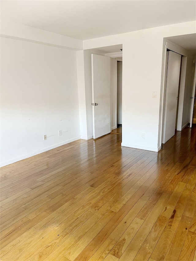 spare room with light hardwood / wood-style flooring