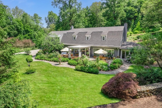 back of property with a gazebo, a lawn, and a patio area