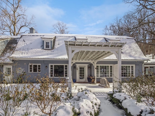 view of snow covered rear of property