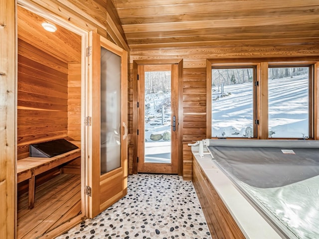 interior space featuring wooden ceiling and wooden walls