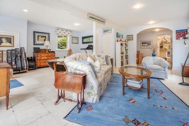 living room with arched walkways, light tile patterned flooring, and recessed lighting