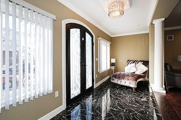 entrance foyer with decorative columns, french doors, and ornamental molding