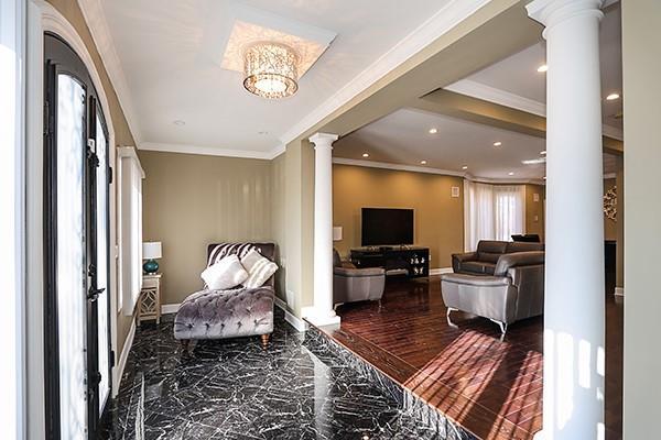 interior space featuring ornamental molding and ornate columns