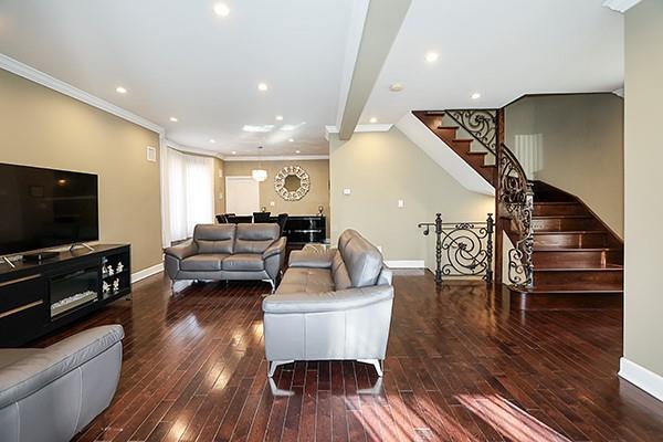 living room with ornamental molding and wood-type flooring