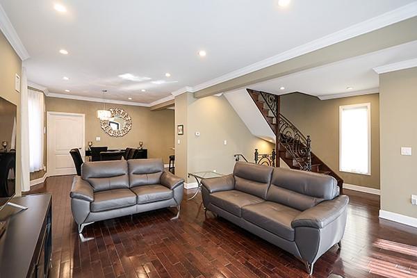 living room featuring crown molding and dark hardwood / wood-style flooring