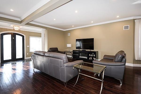 living room with crown molding, french doors, dark hardwood / wood-style floors, a notable chandelier, and beamed ceiling