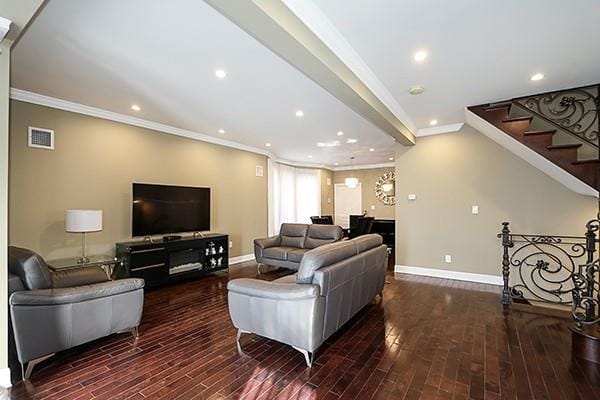 living room featuring crown molding and dark wood-type flooring