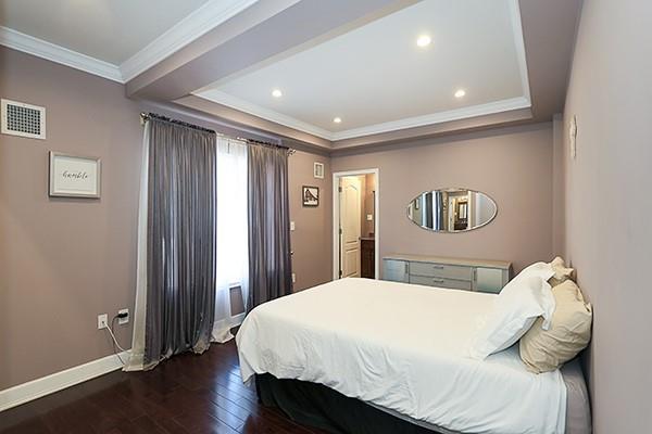 bedroom featuring dark wood-type flooring and ornamental molding