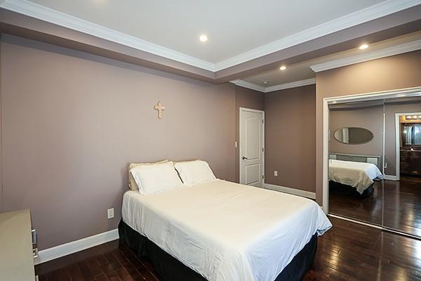 bedroom featuring a closet, ornamental molding, and dark hardwood / wood-style flooring