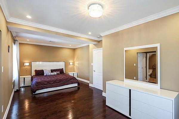 bedroom with crown molding and dark hardwood / wood-style flooring