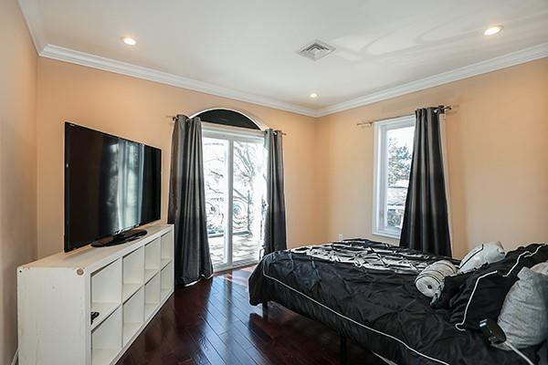 bedroom featuring crown molding, access to exterior, and dark hardwood / wood-style flooring