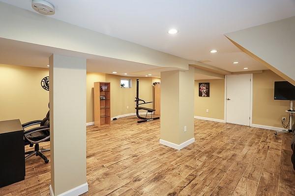 basement with light hardwood / wood-style floors