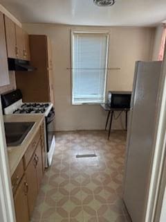 kitchen featuring stainless steel fridge and range with gas stovetop