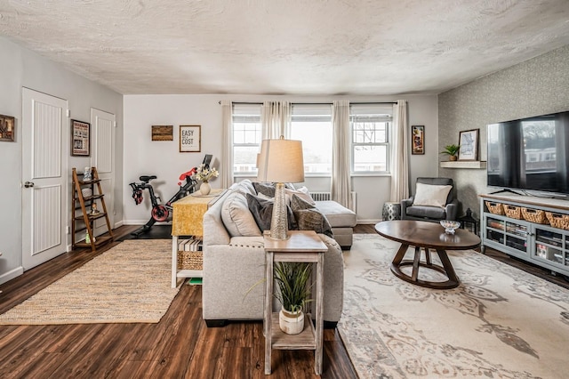 living room featuring a textured ceiling and dark hardwood / wood-style floors