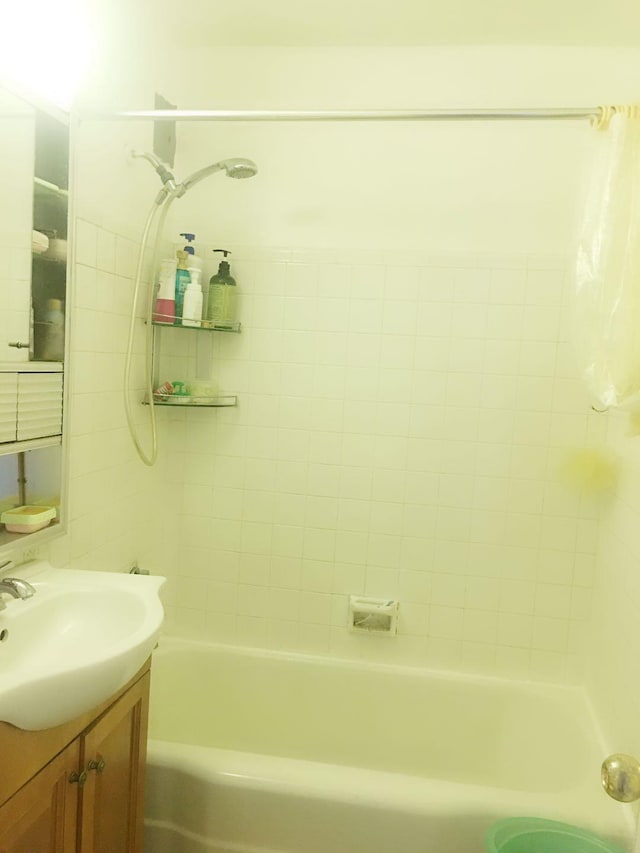 bathroom with vanity and tiled shower / bath combo