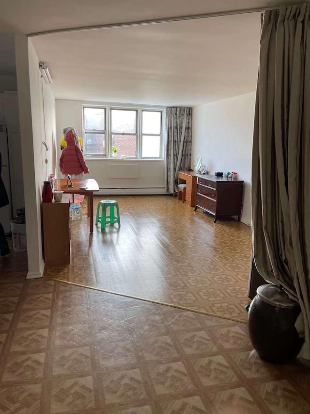 rec room with parquet flooring and baseboard heating