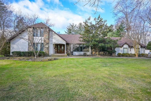 tudor-style house featuring a front yard