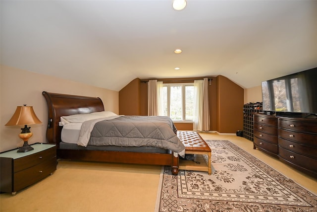 bedroom featuring light carpet and lofted ceiling