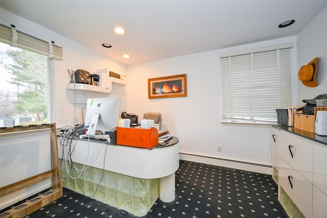 office featuring dark carpet and a baseboard heating unit