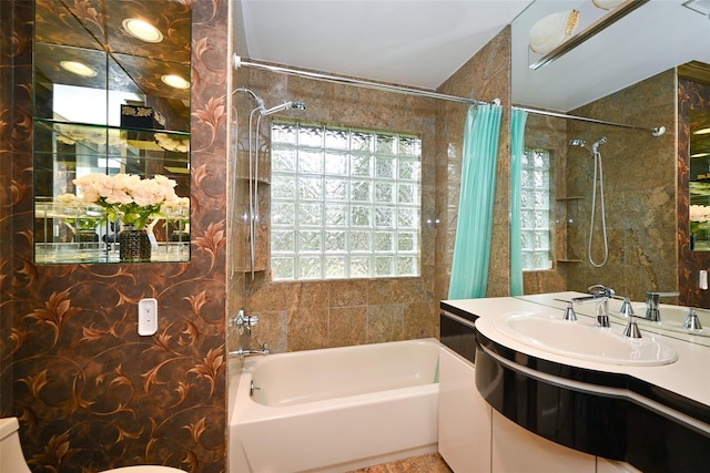 full bathroom featuring toilet, vanity, shower / tub combo with curtain, and a wealth of natural light