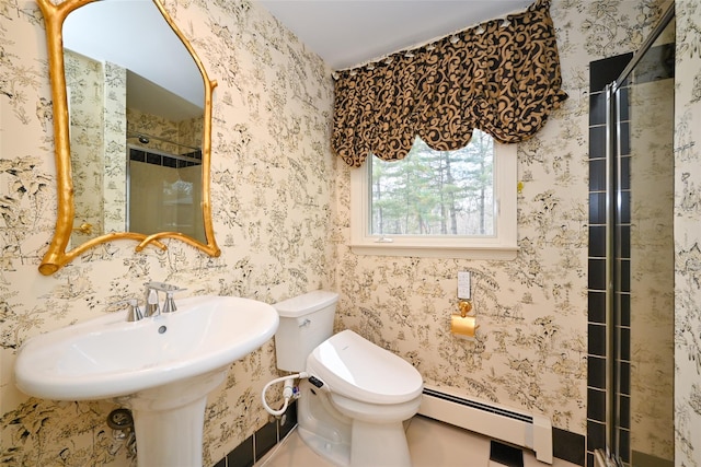 bathroom featuring toilet and baseboard heating